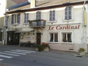 a building on the side of a street at le cardinal in Culoz