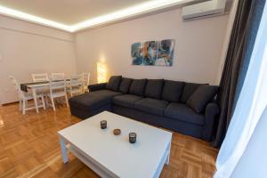 a living room with a couch and a table at Athina Pantheon Mitropoleos in Thessaloniki