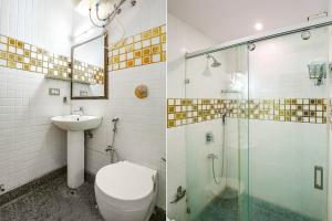 a bathroom with a toilet and a shower and a sink at FabHotel F9 NSP in New Delhi