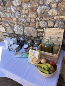 a table with a bowl of fruit and a box of juice at Terra d'Ombra Bed&Breakfast in San Gimignano