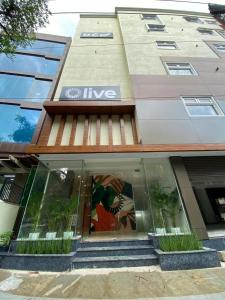 a building with a live sign on the front of it at Olive HAL 2nd Stage - by Embassy Group in Bangalore