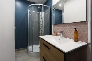 a bathroom with a sink and a shower at Romance O'Berry in Châteauroux