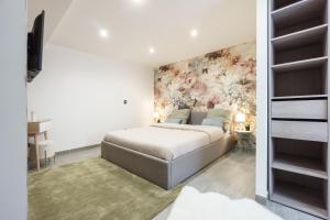 a bedroom with a bed and a wall mural at Romance O'Berry in Châteauroux