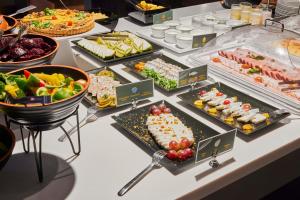 a buffet with many different types of food on a table at Comfort Hotel LT - Rock 'n' Roll Vilnius in Vilnius