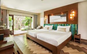a large bedroom with two beds and a large window at Sea Sand Sun Resort and Villas - SHA Plus in Na Jomtien