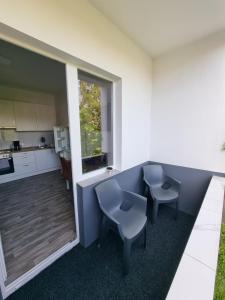 a kitchen with two chairs and a table in a room at Viktoria's Appartment in OB-Mitte in Oberhausen