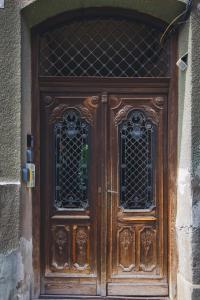 a wooden door with two windows on a building at Rabbit Hole Superior Extension in Sibiu