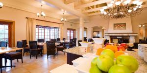 The Caledon Hotel and Spa في كاليدون: لوبي مع غرفة طعام مع طاولات وكراسي