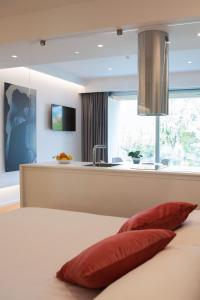 a bedroom with a bed with two red pillows at Marina Gardens Boutique&Suites in Francavilla al Mare
