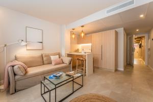 a living room with a couch and a table at ARTIEM Apartamentos in Mahón