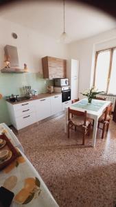 a kitchen with a white table and a table and a table at CASA PEONIA Lovely Flat in Moneglia