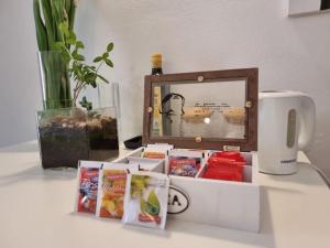 a table with a clock and books and a mug at Il rifugio in Trento