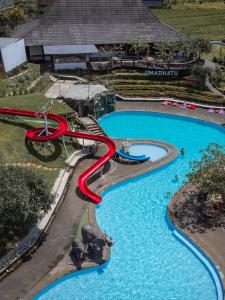 a water slide in a pool at a resort at Umadhatu Resort by Amerta in Tabanan