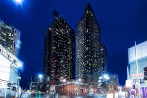 a group of tall buildings in a city at night at Sakura Serviced Apartments in Melbourne