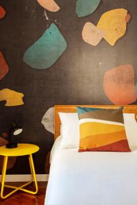 a bedroom with a bed and a table and a wall at Casa Cervantes in Naples