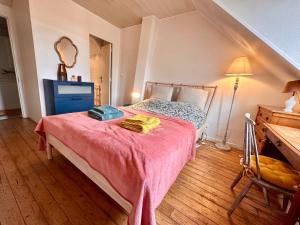 een slaapkamer met een bed met twee handdoeken erop bij Sur le chemin des peintres in Auvers-sur-Oise