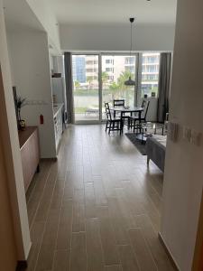 an empty living room with a table and a dining room at Brand new Studio on Yas Island, Abu Dhabi in Abu Dhabi