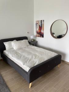 a bed in a bedroom with a mirror on the wall at Brand new Studio on Yas Island, Abu Dhabi in Abu Dhabi