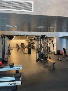 a gym with several treadmills and machines at Brand new Studio on Yas Island, Abu Dhabi in Abu Dhabi