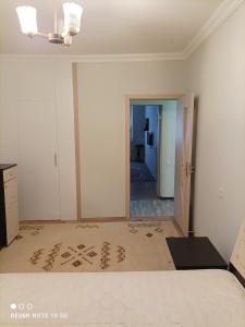 ein leeres Wohnzimmer mit einem weißen Zimmer mit einer Tür in der Unterkunft Nakhchivan Center in Nachitschewan