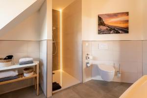 a bathroom with a toilet and a sink at Landhaus Nienhagen in Nienhagen