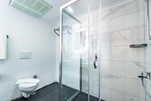 a bathroom with a shower and a toilet at Costa Bitezhan Hotel - All Inclusive in Bitez