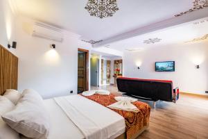 a bedroom with a large bed and a piano at Costa Bitezhan Hotel - All Inclusive in Bitez