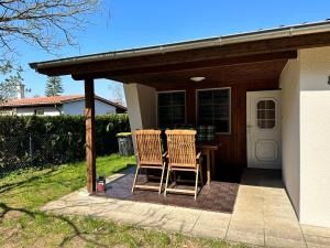 two chairs sitting on the porch of a house at Bungalow am Dobbertiner See in Dobbertin