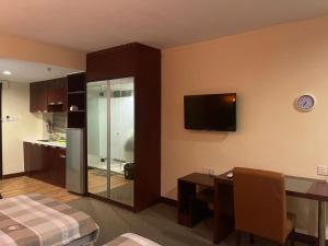 a room with a kitchen and a living room at MJ STUDIO ROOM in Kota Kinabalu