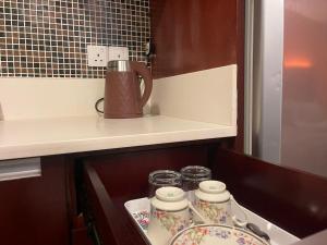 a kitchen with a coffee mug and plates on a stove at MJ STUDIO ROOM in Kota Kinabalu +20 photos