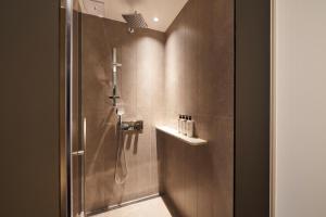 a shower stall in a bathroom with a shower at Nine Tree Premier ROKAUS Hotel Seoul Yongsan in Seoul