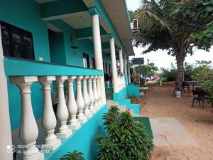 a blue and white building with a white railing at Dee Joy's Beach Place in Calangute