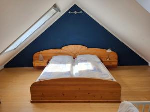 a bedroom with two wooden beds in a attic at Ferienwohnungen Bonnleiten Familie Stöger in Stössing