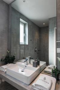 a bathroom with a white sink and a mirror at Superior One Luxury Apartments in Thessaloniki