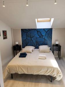 a bedroom with a large bed with two towels on it at Maison de village rénovée in Metz