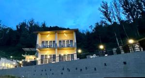 a white house with lights on top of it at Ponmari Villa in Ooty