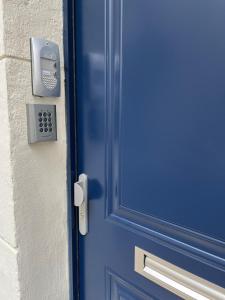 une porte bleue avec serrure sur un bâtiment dans l'établissement Studio pratique, Garage gratuit, Esprit Auber, à Béziers