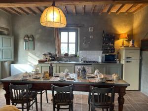 a kitchen with a large wooden table and chairs at Borgo Cardaneto in Montone