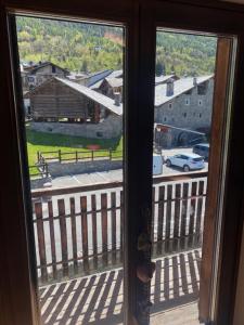 a window with a view of a street and a building at Casa OLMA in Aosta