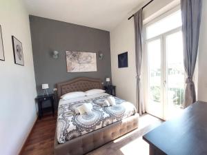a bedroom with a bed and a large window at Savieri Home in Florence in Florence
