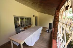 a dining room with a table and a window at Waikiki Guest House Kiminini in Kiminini