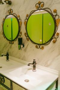 a bathroom with two mirrors above a sink at Camping Playa La Bota in Punta Umbría