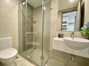 a bathroom with a shower and a toilet and a sink at Homestay Ocean park Gia Lâm in Hanoi +35 photos