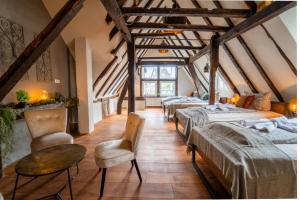 a room with four beds and a table and chairs at Haus zum Ring in Adenau
