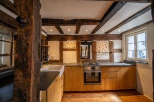 a kitchen with wooden cabinets and a sink and a window at Haus zum Ring in Adenau