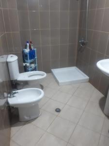 a bathroom with a toilet and a sink at Apartament in Shëngjin