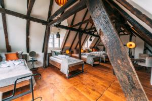 a room with four beds in a attic at Haus zum Ring in Adenau