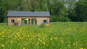a small house in a field of flowers at Le Domaine Des Anges, écolodge in Thenay