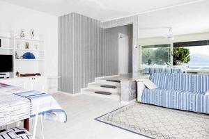 a living room with a couch and a table at Villa Gardesana Torri del Benaco in Torri del Benaco
