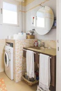 a bathroom with a sink and a washing machine at Villa Gardesana Torri del Benaco in Torri del Benaco